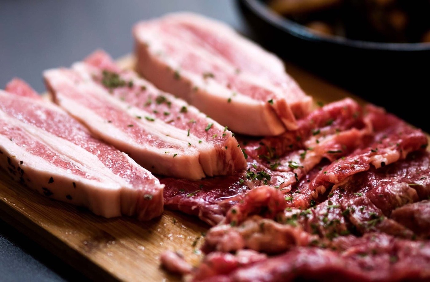 Premium seared pork belly and beef on a cutting board
